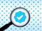 Seattle, WA USA - circa November 2022: Out of focus image of a magnifying glass zooming in on the Twitter Verification logo