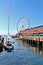 Seattle, Washington, 9/14/17, Seattle waterfront restaurant with a sailboat docked and The Great Wheel in the bachground