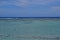 Seaview with horizon that separates water and sky with the shallow water having greater visibility