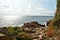 Seaview with the rocky coastline and sun reflection on the water