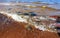 Seawater and waves flooding colored stones on the beach.