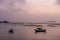 At the seaweed farm before sunrise in the morning, there are seaweed rows and boats