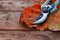 Secateurs and autumn leaf on rustic wooden table