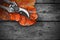 Secateurs and autumn leaf on rustic wooden table