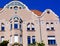 Secessionist or art nouveau style facade detail with bay windows. sloped clay tile roof