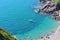 Secluded Beach with blue sea, boat and canoe