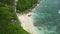 Secluded Beach Under Steep Cliffs of Uluwatu. Bali Island, Indonesia. Drone Shot