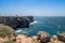 Secluded lighthouse on top of cliff at Atlantic coast in the Algarve, Portugal, with sunny weather