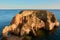 Secluded limestone island and beach Praia JoÃ£o de Arens in Algarve, Portugal