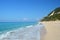 Secluded sandy beach in quiet sunny day with calm turquoise sea