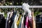 Second hand women\'s jackets on display at flea market