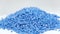 Secondary granule made of polypropylene, Blue Plastic pellets crumbles to the table . Plastic raw materials in granules for indust