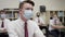 Secondary school students in UK wear masks in class as teen boy looks at teacher