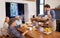 Seconds for grandpa. A cropped shot of a happy man serving his family a deliciously cooked breakfast.