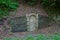 Secret door in hillside - walled up archway with fountain pipe in center and water leaking out from spring inside in abandoned