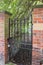 Secret garden. Iron gate with padlock at walled garden entrance