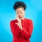 Secret, gossip and black woman in studio pointing isolated on a blue background. Happy, whisper and African person with