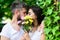 Secret romantic kiss. Love romantic feelings. Moment of intimacy. Couple in love hiding behind bouquet flowers kiss