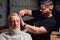 Secrets of trendy haircut.handsome old man getting his hair done