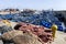 A section of the busy fishing harbour at Essaouira in Morocco showing fishing nets, small boats and trawlers.