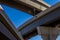 Section of elevated highway with several levels against a bright blue sky in Houston, Texas