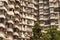 Section from the exterior of an residential building, all balconies full of laundry hanged, Mumbai,