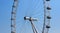 Section of ferris wheel in London against clear blue sky