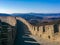 A section of the Great Wall of Mu Tian Yu Chang Cheng filmed in a winter sunny day against the backdrop of the mountains