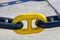 Section of nautical chain with yellow chain link