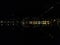 Section of nighttime panorama of Como, Italy. Lights of the town in black night, reflected in the water of the Como lake