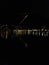 Section of nighttime panorama of Como, Italy. Lights of the town in black night, reflected in the water of the Como lake