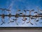 A section of a rotating wall top anti-climb security barrier, taken against a blue sky on a sunny day