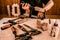 A section of wood worker gluing wood pieces together, lamination with iron clamps on the workbench in atelier