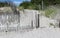 Sections of old worn fencing at the edge of the shore