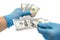 Secure money transfer.hand in rubber glove takes money.hands in sterile medical gloves concept on theme of corruption in medicine