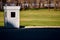 Security booth in the parking lot in the open area. photo. sun and shadow. green grass