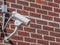 Security camera, CCTV on brick wall background