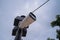 Security camera hanging among wire in guarded bridge with cloudy sky background