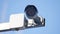 Security camera and urban video surveillance protection against theft of thieves against the blue sky outdoors