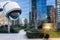 security CCTV camera or surveillance system with buildings on blurry background