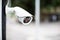 Security CCTV camera surveillance system outdoor of house. A blurred night city scape background.