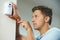 Security Consultant Fitting Burglar Alarm Sensor In Room