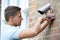 Security Consultant Fitting Security Camera To House Wall