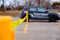 Security guard setting up a caution tape to do parking enforcement at guest parking lot.