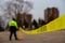 Security guard setting up a caution tape to do parking enforcement at guest parking lot.