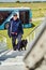 Security officer with black dog climbing aircraft steps