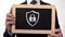 Security padlock icon drawn on blackboard in businessman hands, antivirus safety