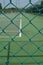 Security wire mesh fence with blurred tennis court background