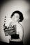 Seductive actress with clapperboard, vintage black and white portrait