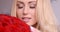 Seductive Blond Woman Behind Red Rose Bouquet